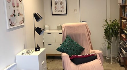 Relaxing therapy room at Emma Bateman Reflexology, York, England, GB with a cozy chair and calming decor.