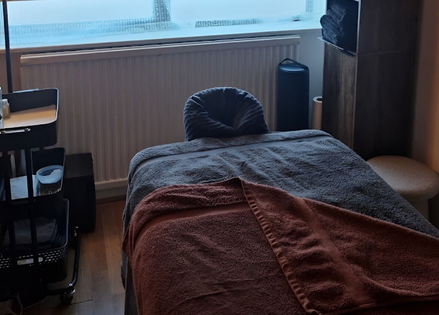 Massage room at MORGAN SPA in Gloucester, England, GB, featuring a cozy massage table with soft lighting.