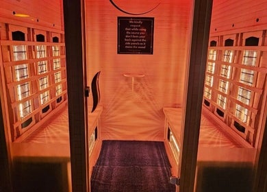 Relaxing sauna room at The Firm Elegance in Beauty, Cape Town, Western Cape, ZA with warm lighting and wooden interiors.