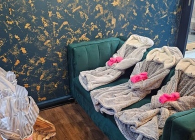 Luxurious robes on green seating at The Firm Elegance in Beauty, Cape Town, Western Cape, ZA.