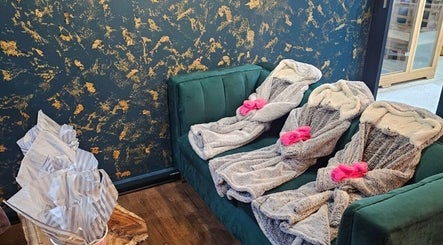 Luxurious robes on green seating at The Firm Elegance in Beauty, Cape Town, Western Cape, ZA.