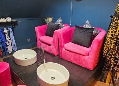Stylish seating at The Firm Elegance in Beauty, Cape Town, Western Cape, ZA with modern pink decor and basin.