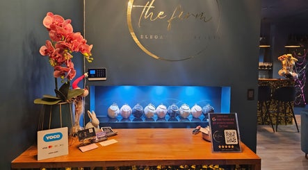 Elegant front desk at The Firm Elegance in Beauty, Cape Town, Western Cape, ZA adorned with orchids.