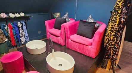 Stylish pink chairs and foot basins at The Firm Elegance in Beauty, Cape Town, Western Cape, ZA.