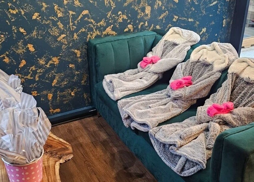 Luxurious robes on green sofa at The Firm Elegance in Beauty, Cape Town, Western Cape, ZA.