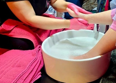 Hand care service at The Firm Elegance in Beauty, Cape Town, Western Cape, ZA with pink towels and warm soak.