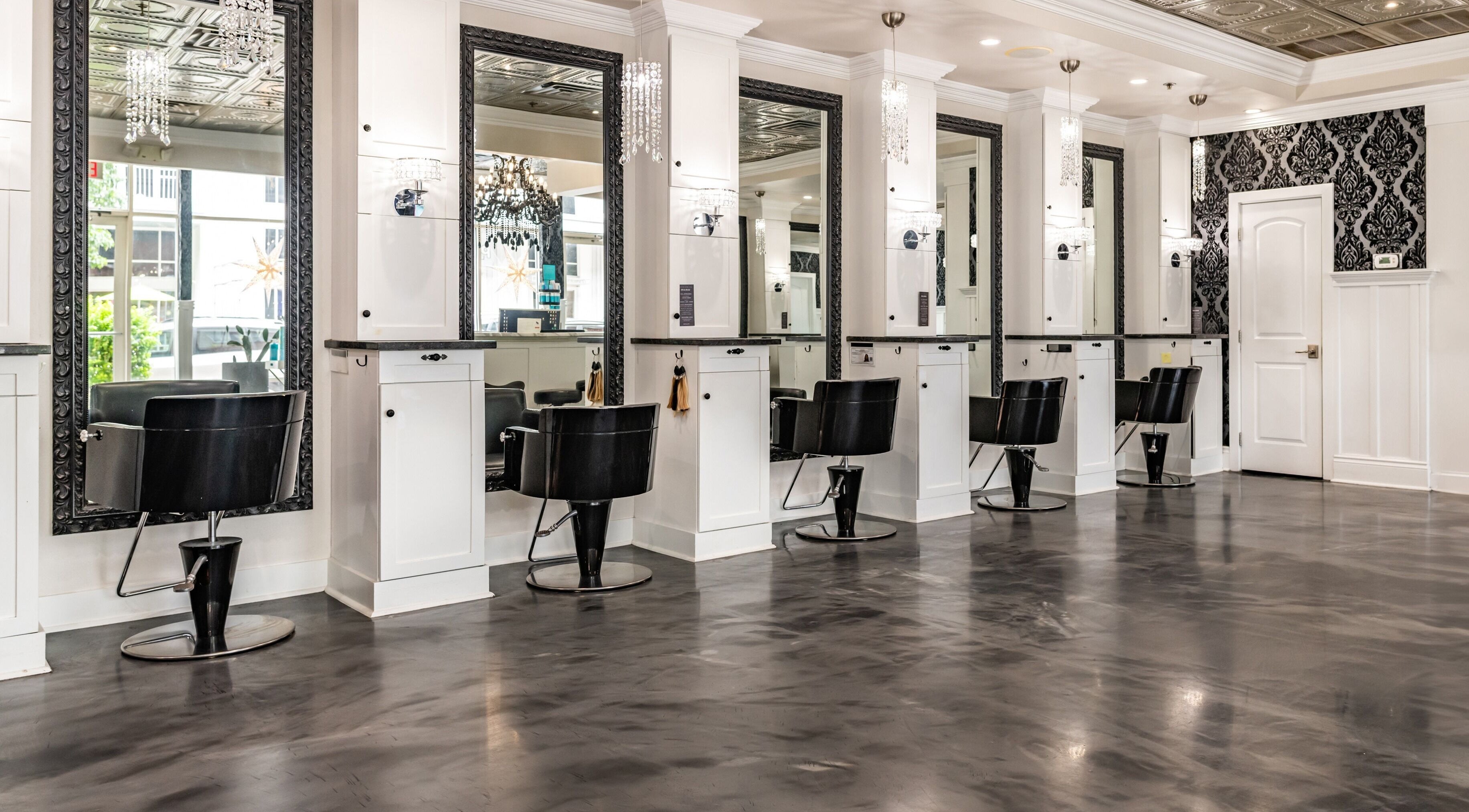 Chic styling area at Atelier Hair Salon in Orlando, Florida, US with modern black and white decor.