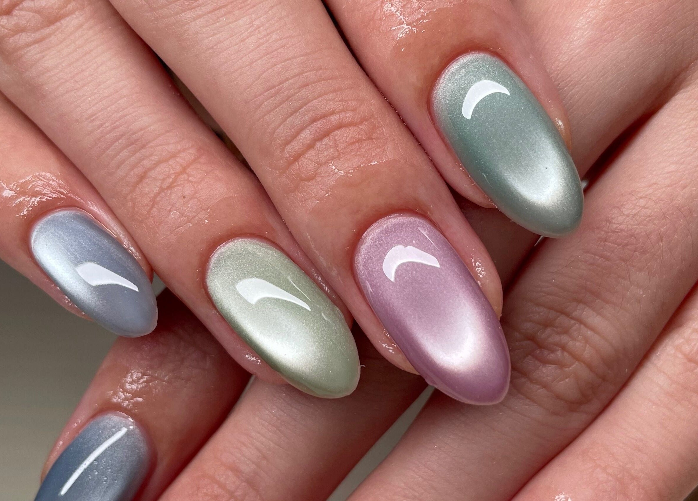 Stylish metallic nails at Montanna Here 2 Glow, London, Ontario, CA, showcasing vibrant nail artistry.