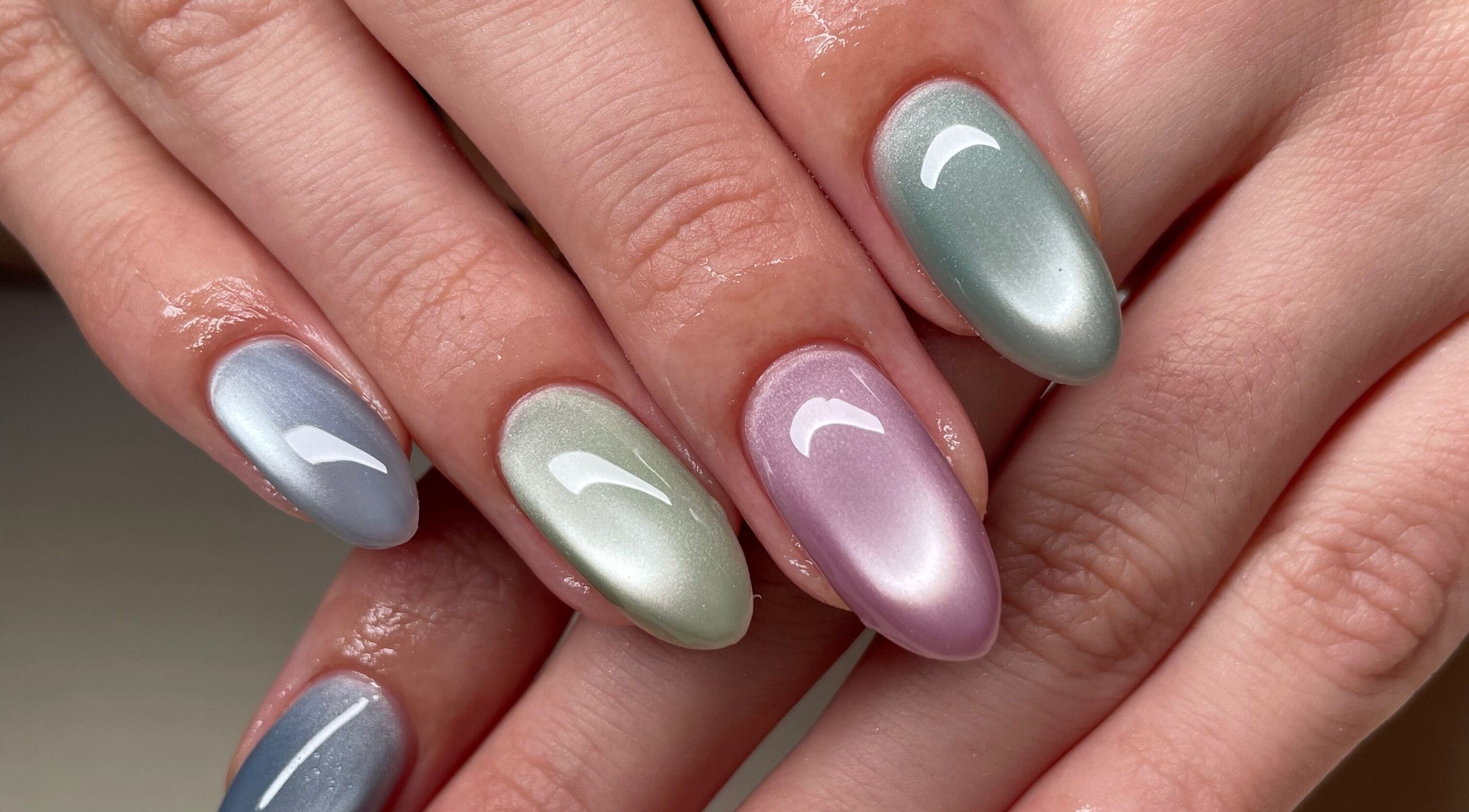 Stylish metallic nails at Montanna Here 2 Glow, London, Ontario, CA, showcasing vibrant nail artistry.