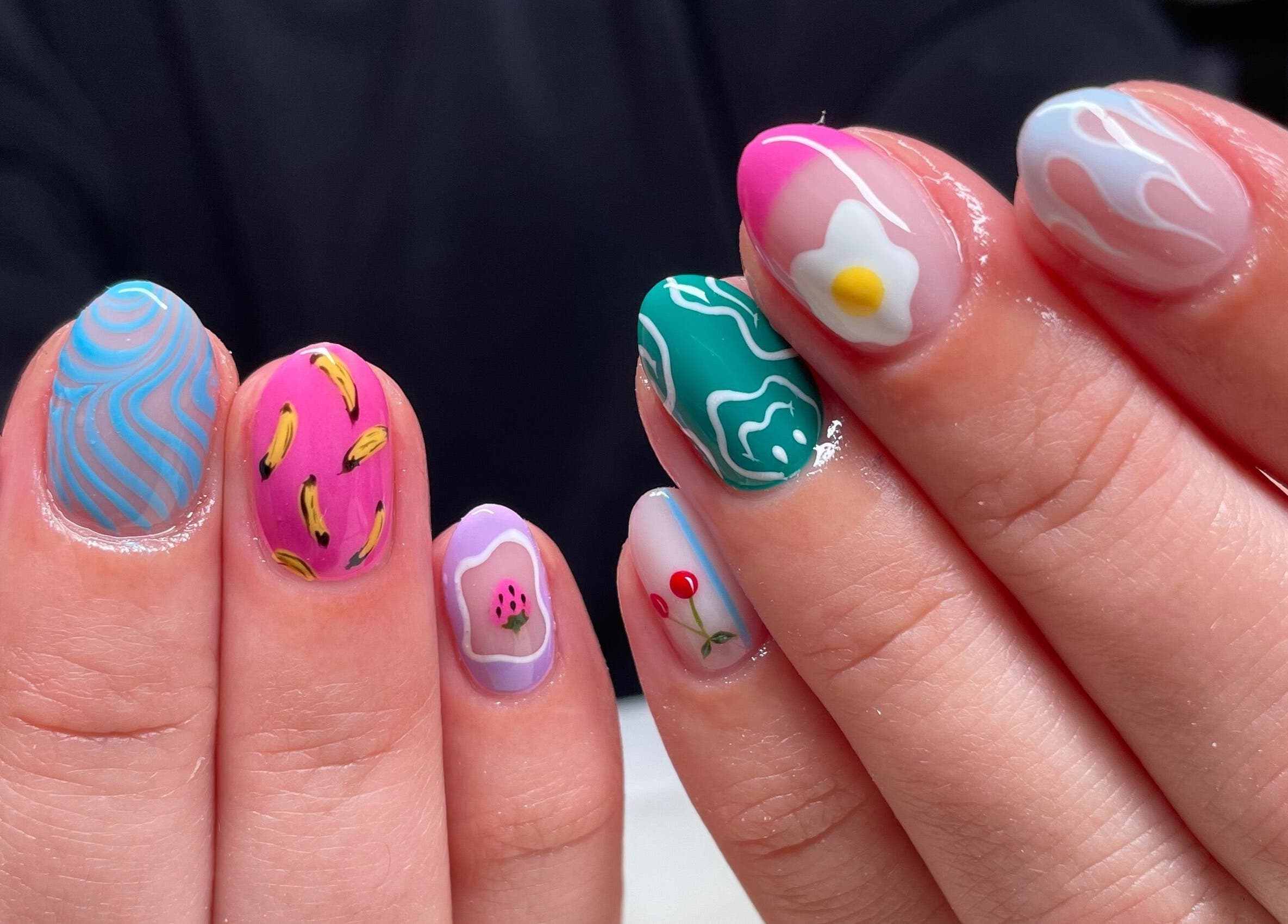 Vivid nail art designs at Montanna Here 2 Glow, London, Ontario, CA, showcasing a creative manicure.