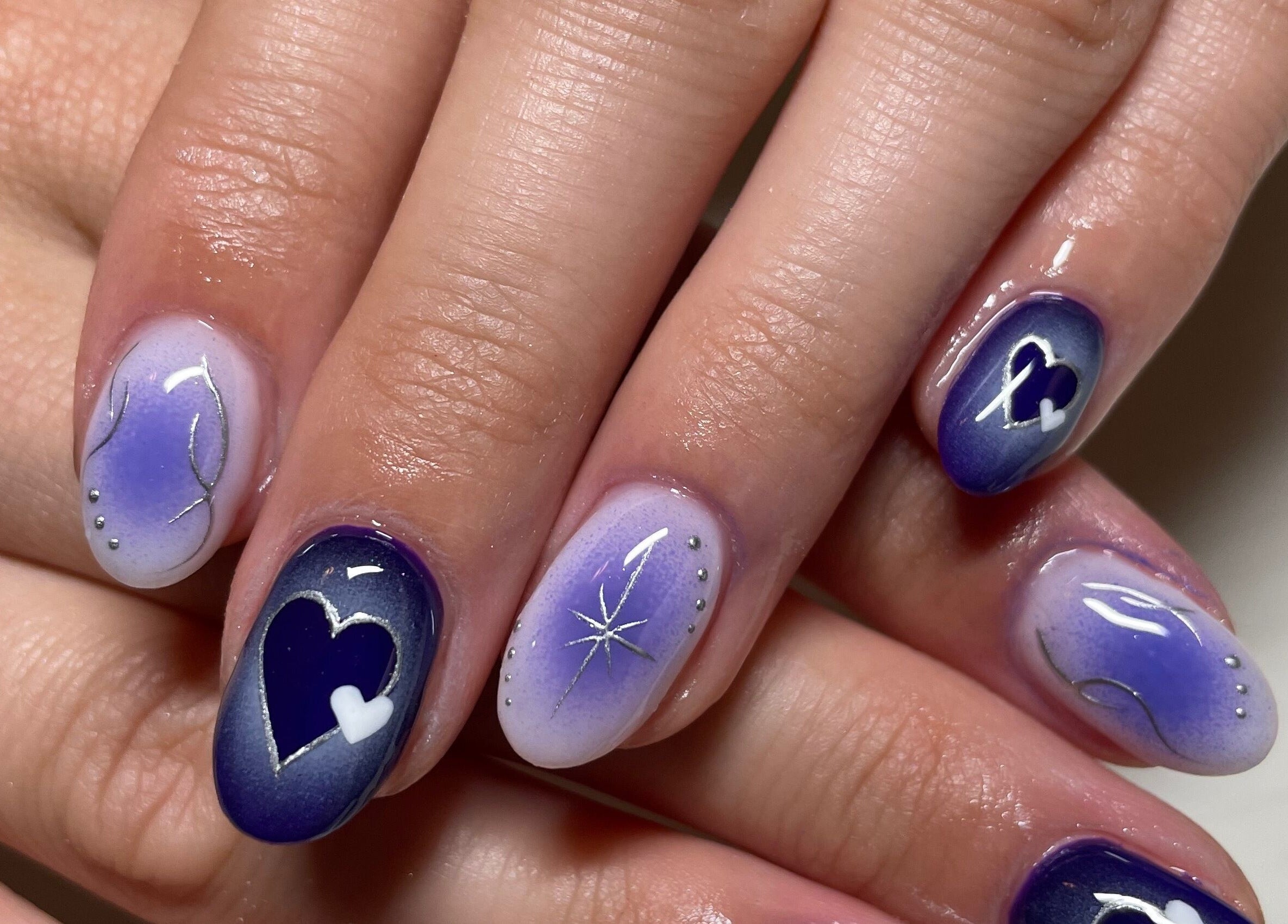 Elegant purple and blue heart-themed nail art at Montanna Here 2 Glow, London, Ontario, CA.