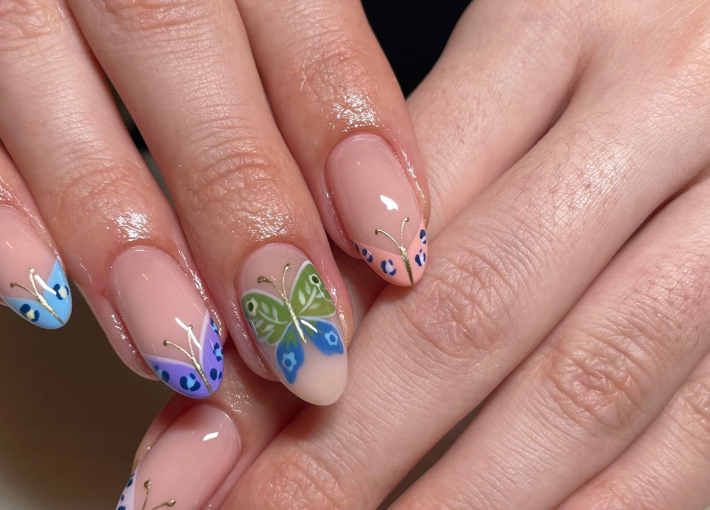 Intricate butterfly nail art at Montanna Here 2 Glow in London, Ontario, CA.
