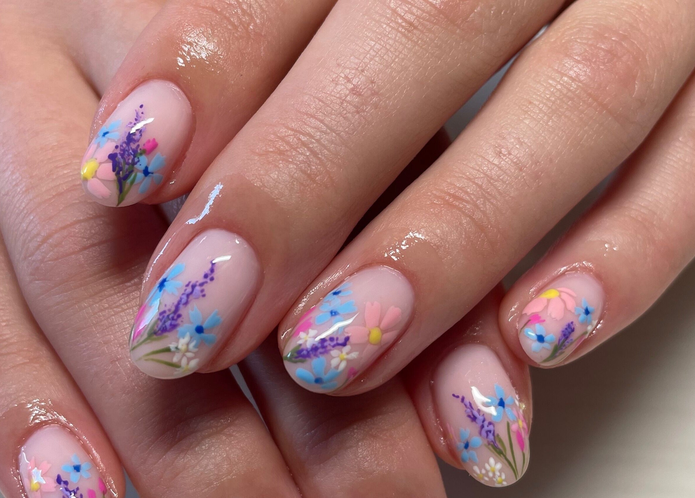 Floral nail art at Montanna Here 2 Glow in London, Ontario, CA, showcasing intricate colorful designs.