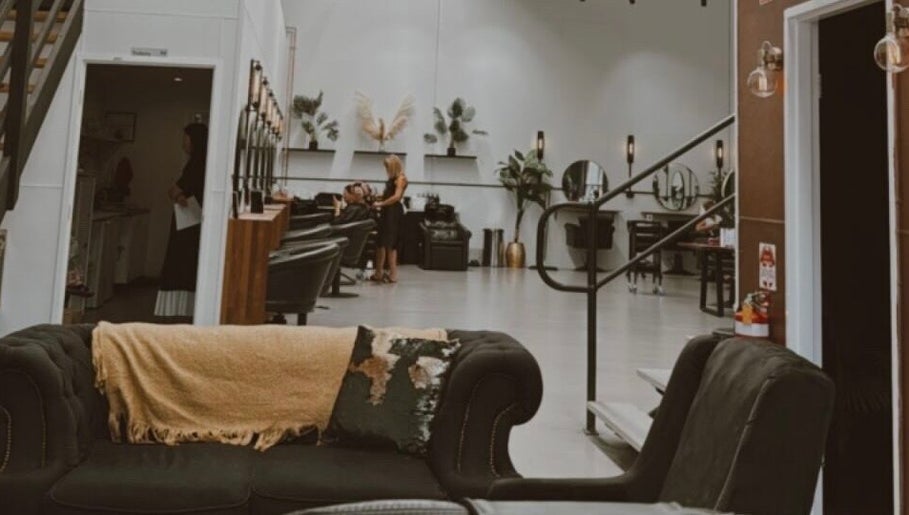 Interior of Fanny’s Barber in Rothwell, Queensland, AU, showcasing stylish seating and modern décor.