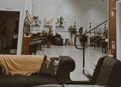 Interior of Fanny’s Barber in Rothwell, Queensland, AU, showcasing stylish seating and modern décor.