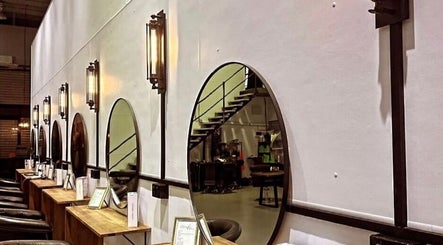 Elegant salon setup at Fanny’s Barber in Rothwell, Queensland, AU featuring stylish mirrors and comfortable seating.
