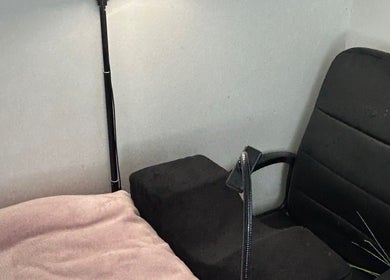 Cozy treatment area with black chair and soft pink blanket at LuxeLashUk, Hornchurch, England, GB.