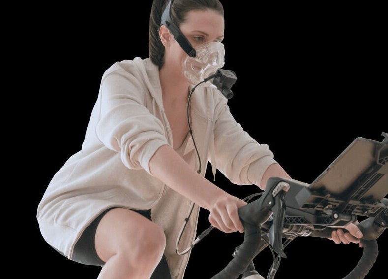 Person cycling with mask at The Zone in Coeur d'Alene, Idaho, US. Fitness and wellness technology.