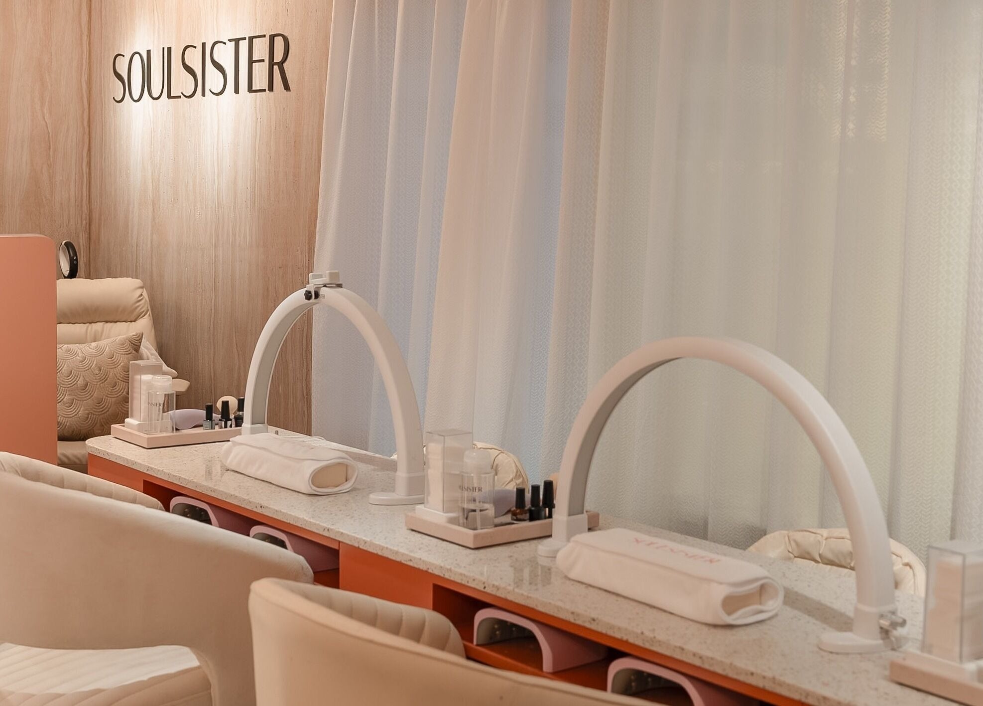 Elegant interior of Soulsister Nail, Hong Kong Island, featuring plush seating and nail care stations.