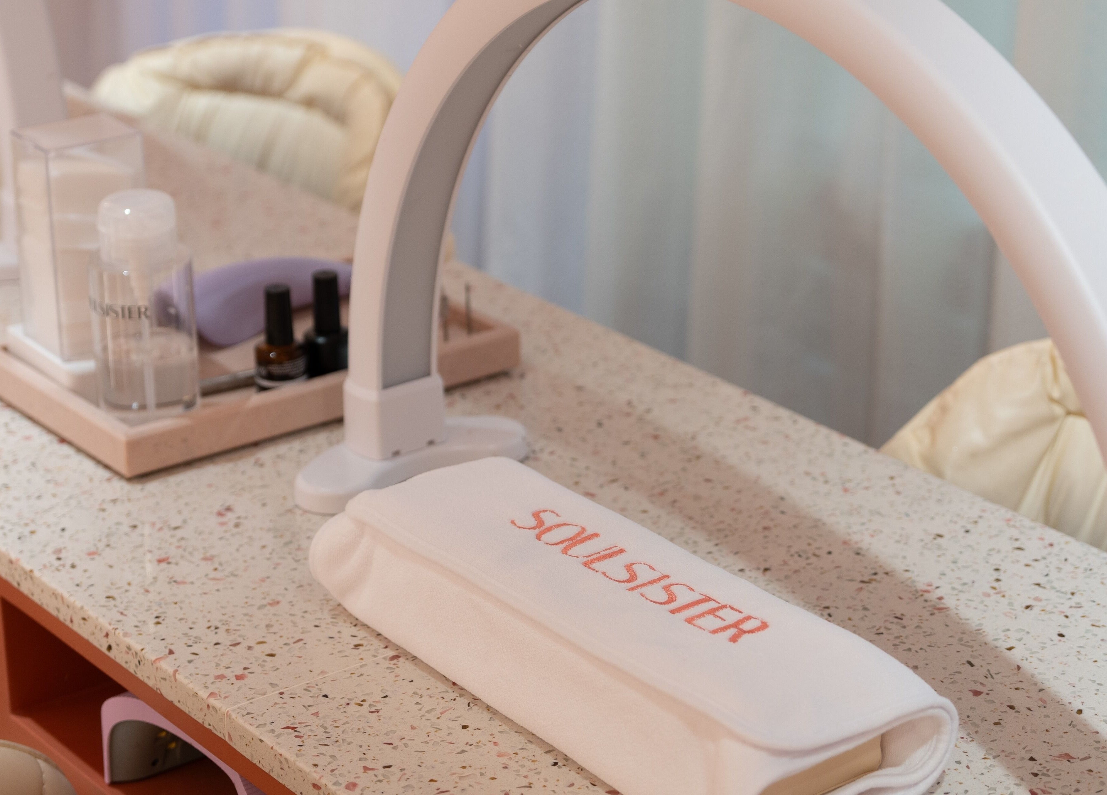 Manicure station at Soulsister Nail, Hong Kong Island, featuring tools and a branded towel.