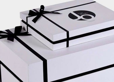 White gift boxes with black ribbons at Jo Hair Studio Vancouver, Vancouver, British Columbia, CA.