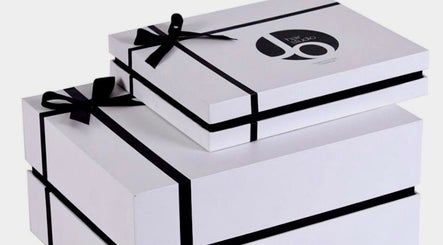 White gift boxes with black ribbons at Jo Hair Studio Vancouver, Vancouver, British Columbia, CA.