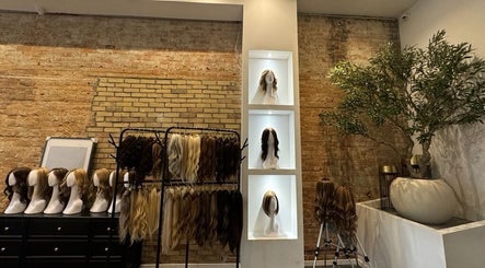 Display of stylish wigs at Jo Hair Studio Toronto, Ontario, CA with exposed brick and greenery.