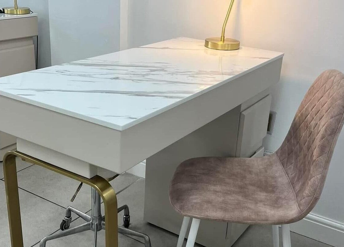 Modern nail station at Vees Vmc, Birmingham, England, GB, featuring a sleek marble desk and plush seating.