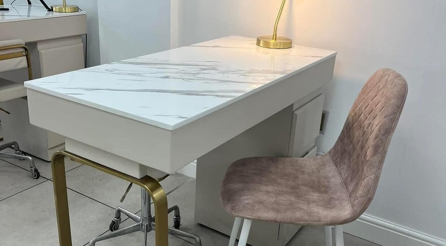 Modern nail station at Vees Vmc, Birmingham, England, GB, featuring a sleek marble desk and plush seating.