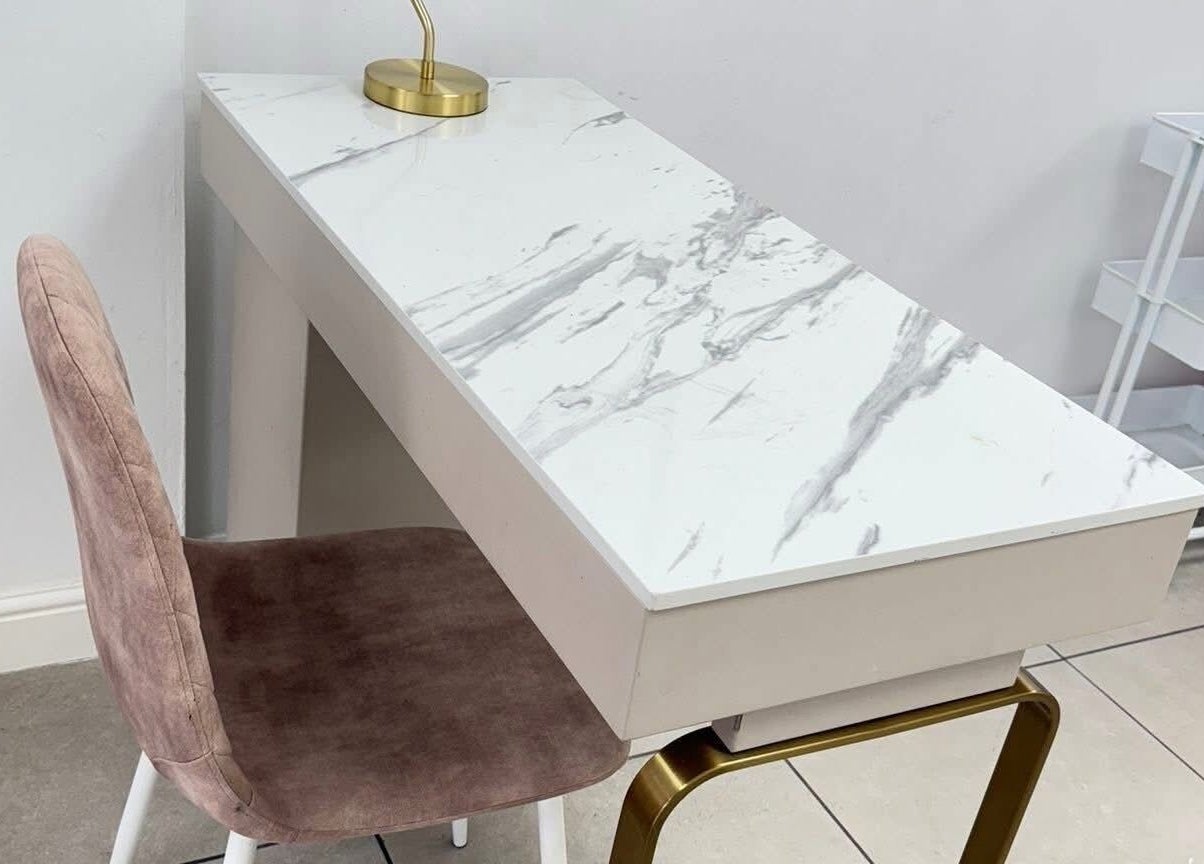 Stylish marble manicure table at Vees Vmc, Birmingham, England, GB, featuring a plush pink chair.
