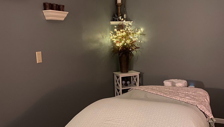 Tranquil massage room at Massage by Melissa, LLC in Wausau, Wisconsin, US with soft lighting and floral decor.