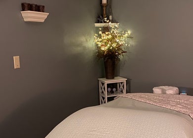 Tranquil massage room at Massage by Melissa, LLC in Wausau, Wisconsin, US with soft lighting and floral decor.