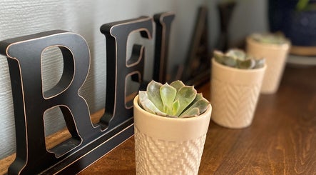 Relax sign with succulents at Massage by Melissa, LLC, Wausau, Wisconsin, US, creating a serene atmosphere.