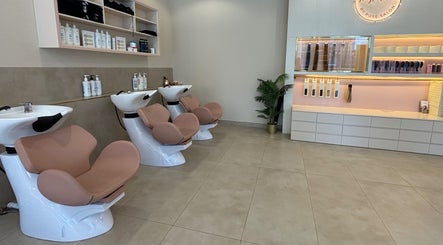 Modern salon interior at Pose Salon, Dubai, Dubai, AE showcasing stylish wash stations and hair care products.