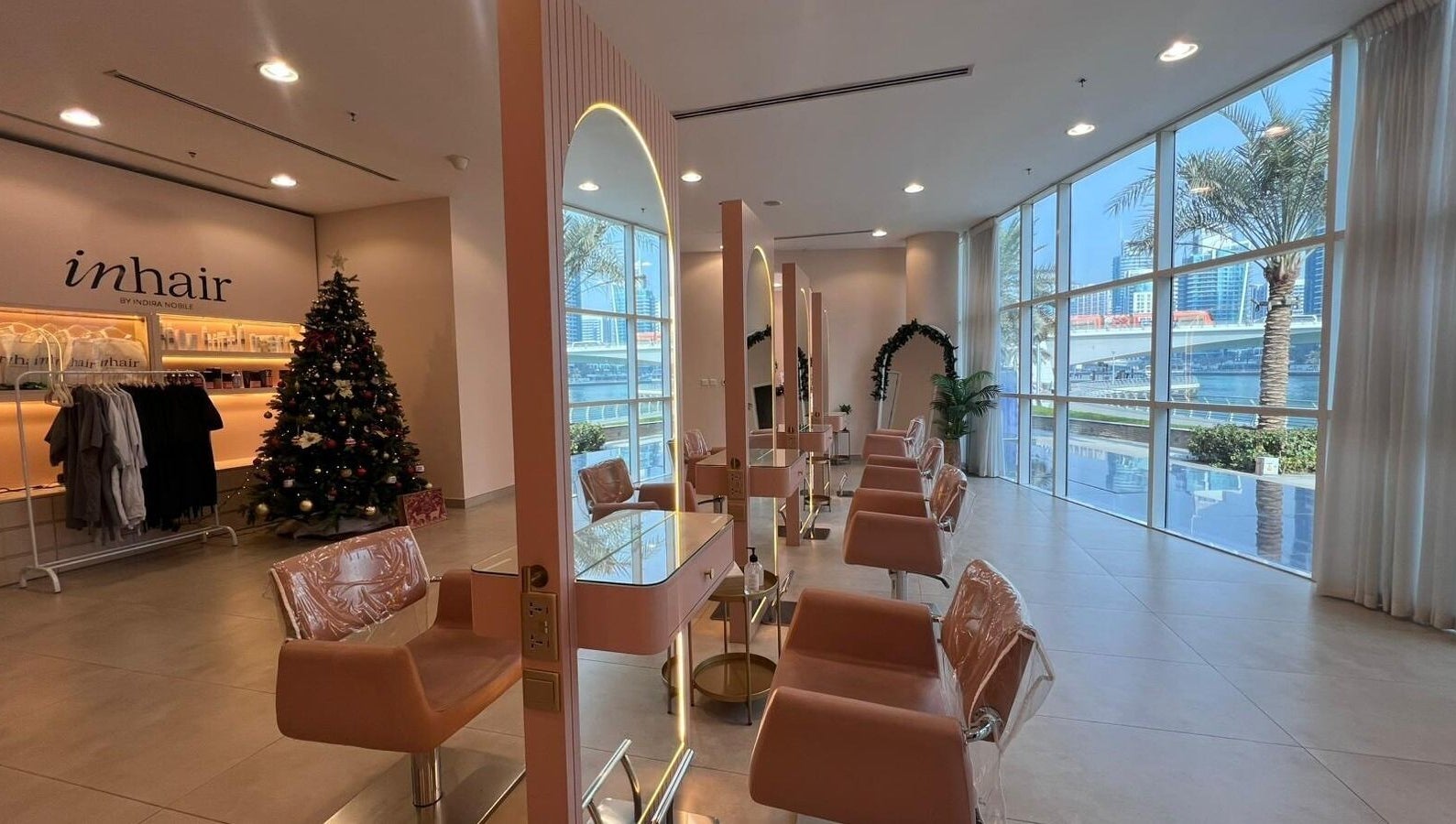 Modern styling stations at InHair Salon, Dubai, Dubai, AE with festive decor and cityscape window view.