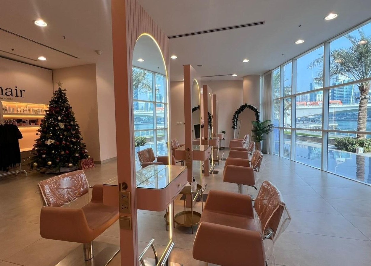 Modern styling stations at InHair Salon, Dubai, Dubai, AE with festive decor and cityscape window view.
