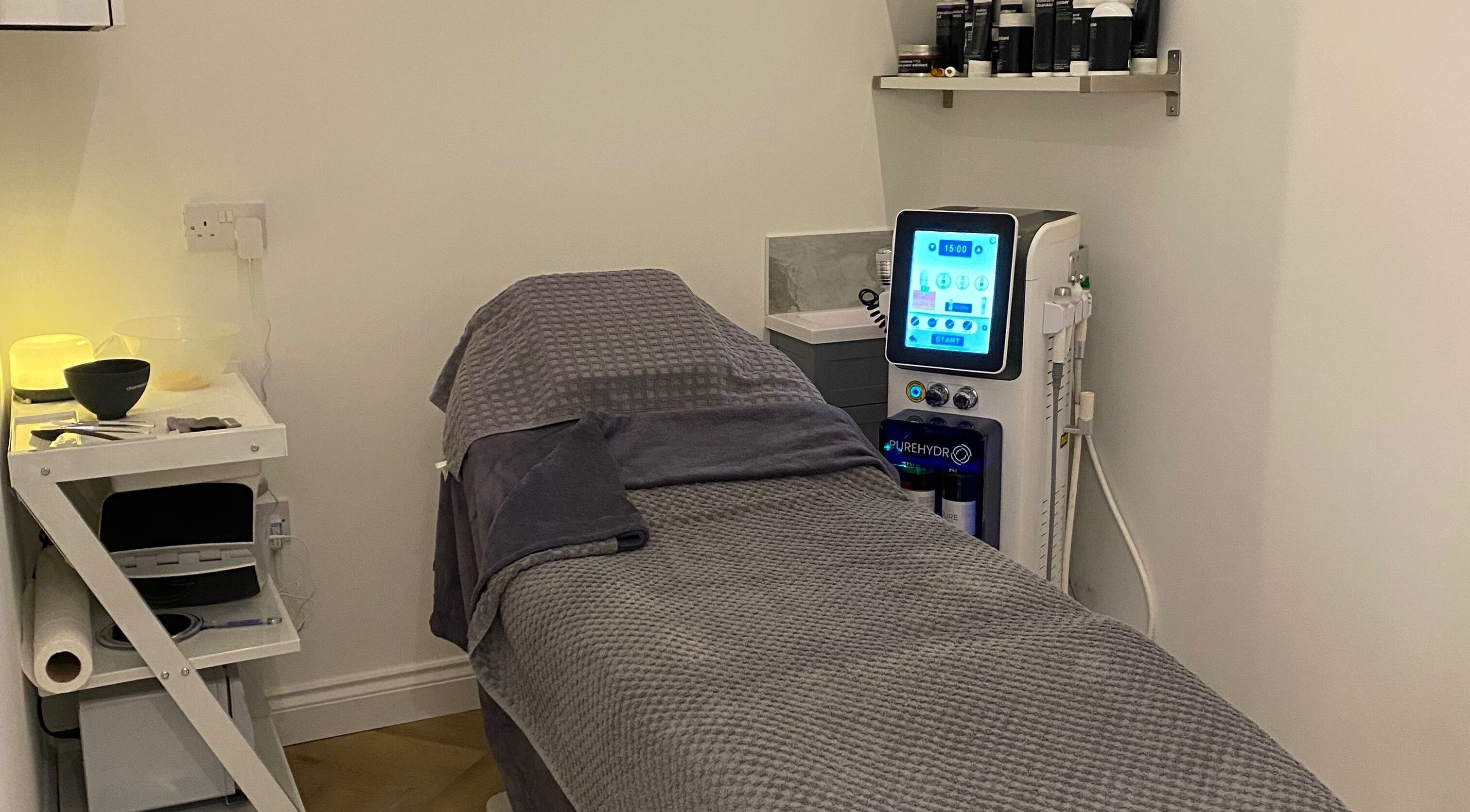 Treatment room at Revive, Rochdale, England, GB, featuring a padded spa bed and modern equipment.