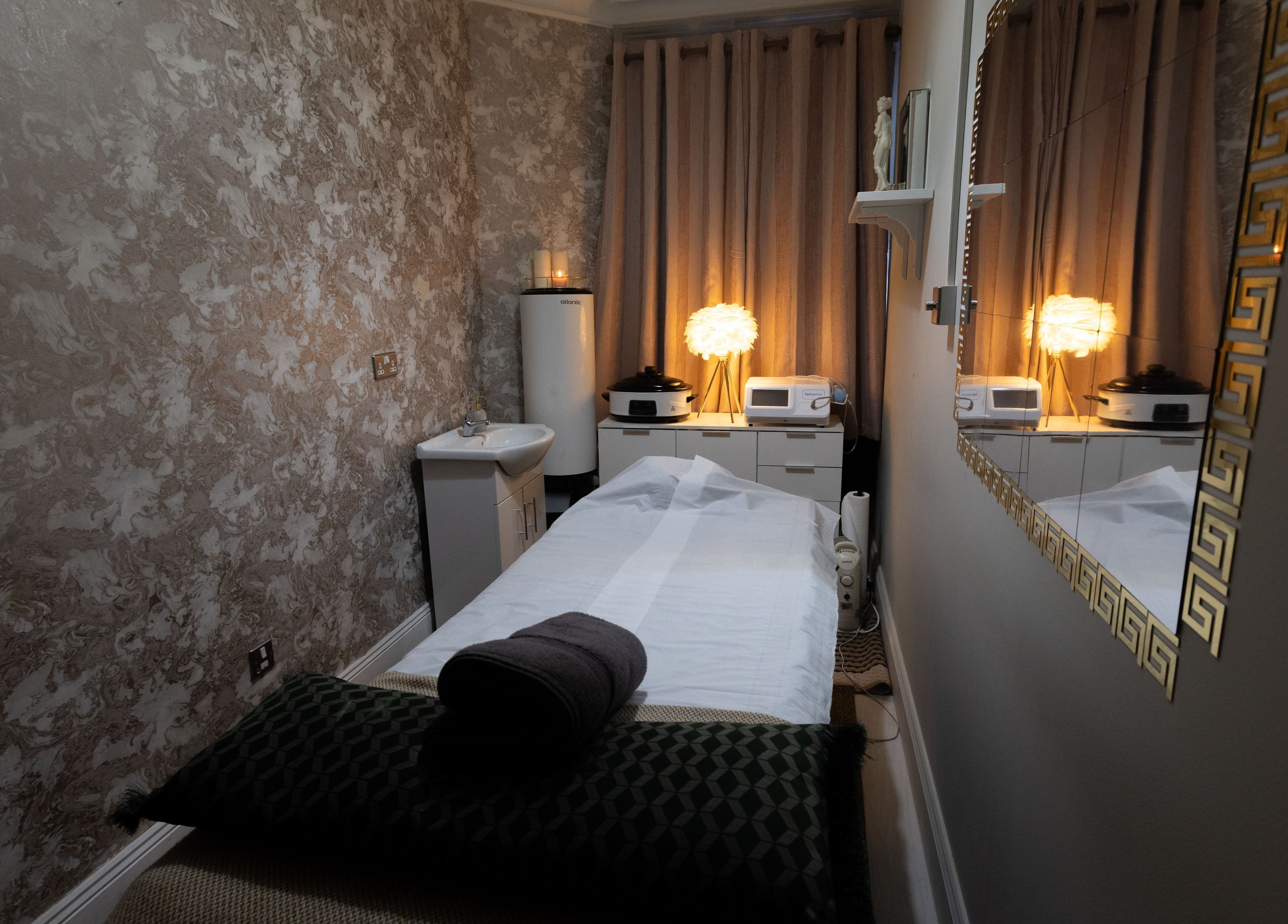 Cozy treatment room at Spa Relax Today, Dublin, County Dublin, IE, with ambient lighting and massage table.