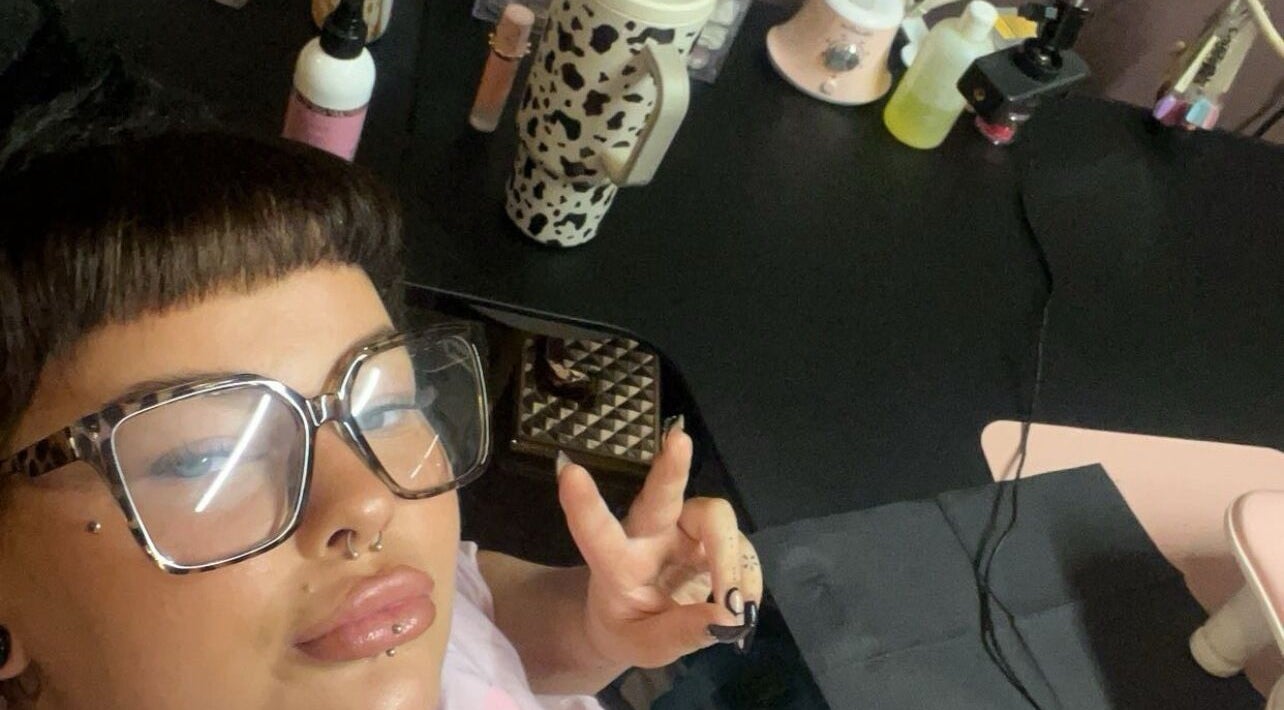 A person with stylish glasses at The Free Edge, a beauty venue in Stornoway, Scotland, GB.