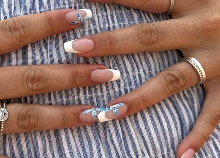 Elegant French manicure with floral accents by Nailed it by Nattareeya, Saint Helier, St Helier, JE.