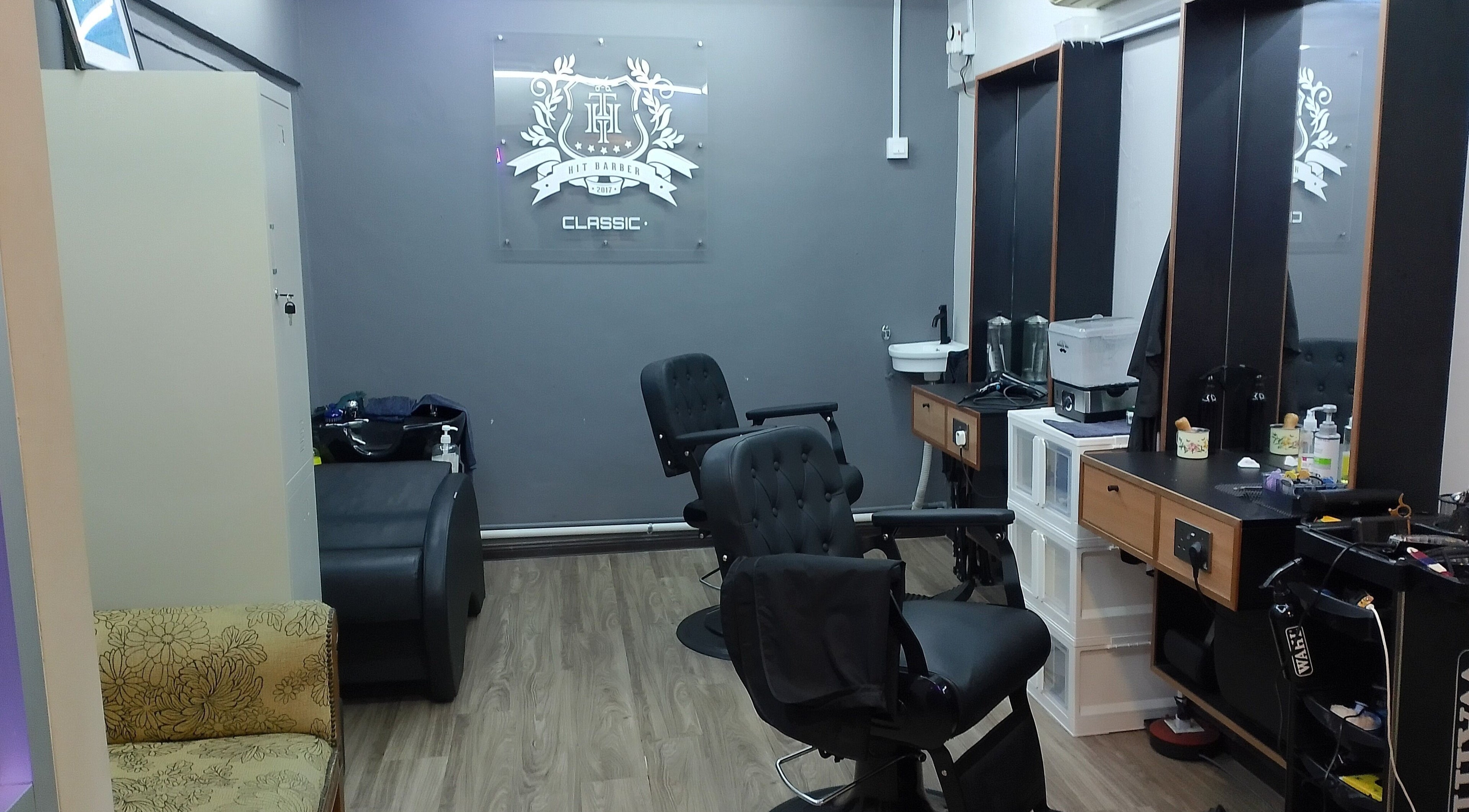 Modern interior of Hit Barber Classic TTDI in Kuala Lumpur, features sleek chairs and styling stations.