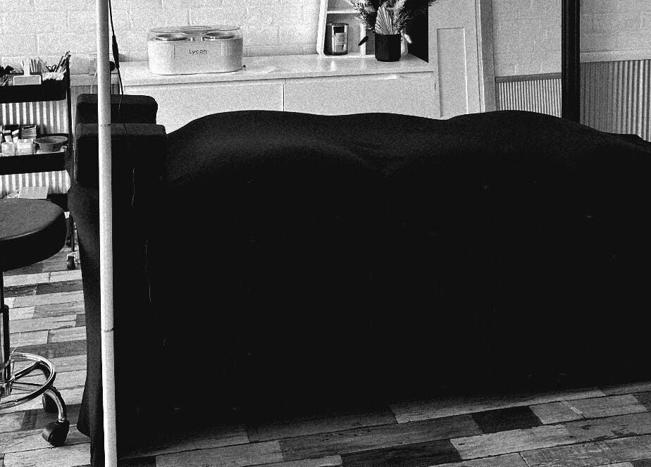 Cozy treatment room at Khai Beauty, Portland, NSW with a massage bed and wellness tools.