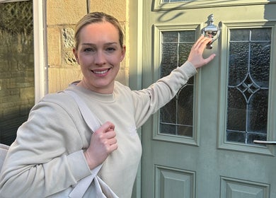 Friendly woman at a green door, representing Mobile Massage with Christie, England, England, GB.
