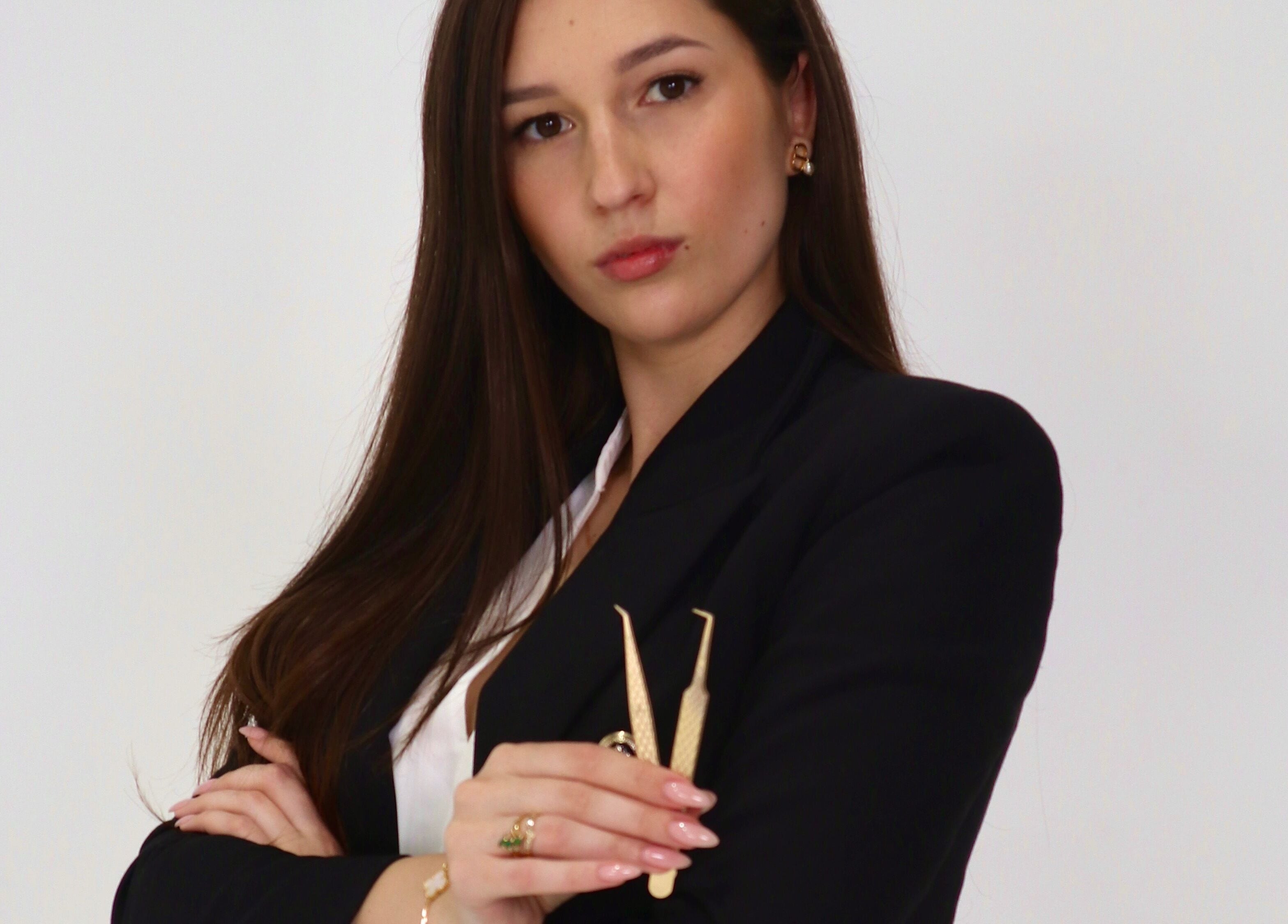 Stylist at Pretty Little Lashes By Suzie, Lightsview, South Australia holding lash tools.