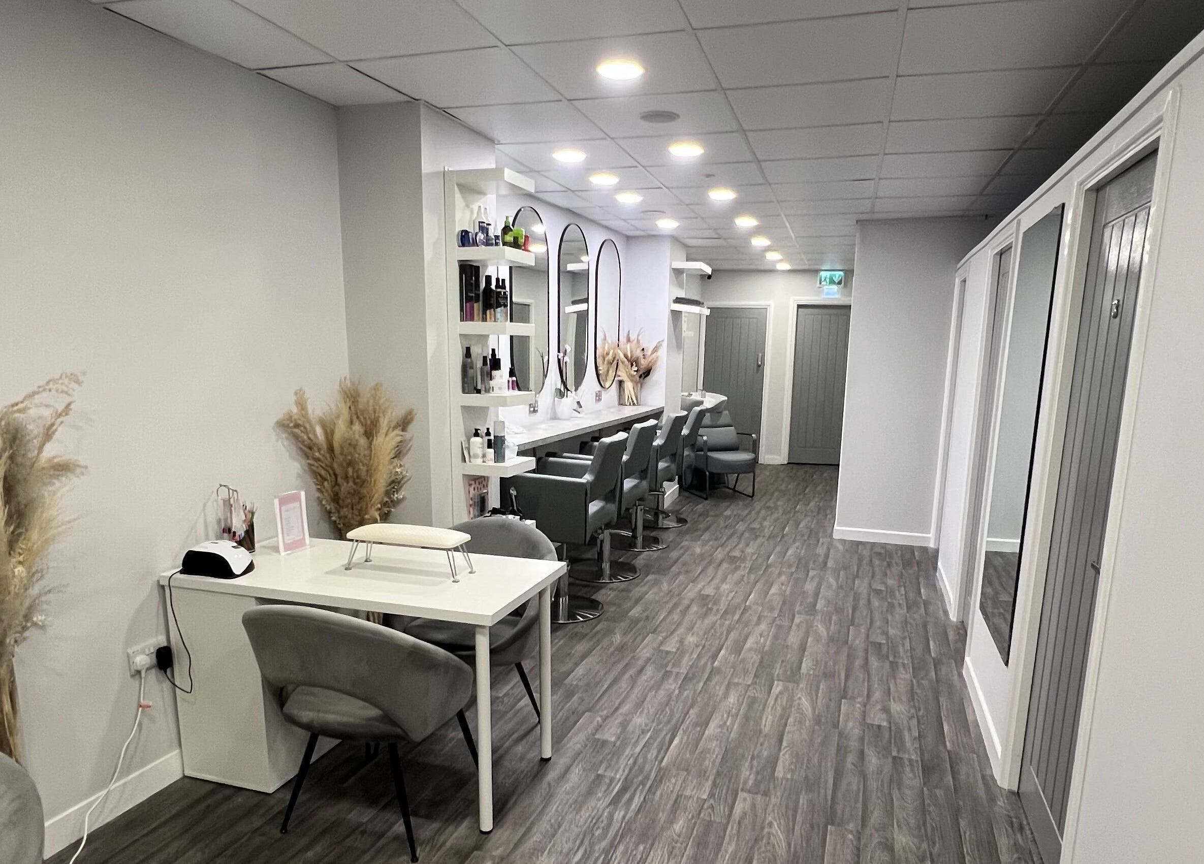 Elegant beauty salon interior at House of Boo, Petersfield, England, GB showcasing modern decor and styling stations.