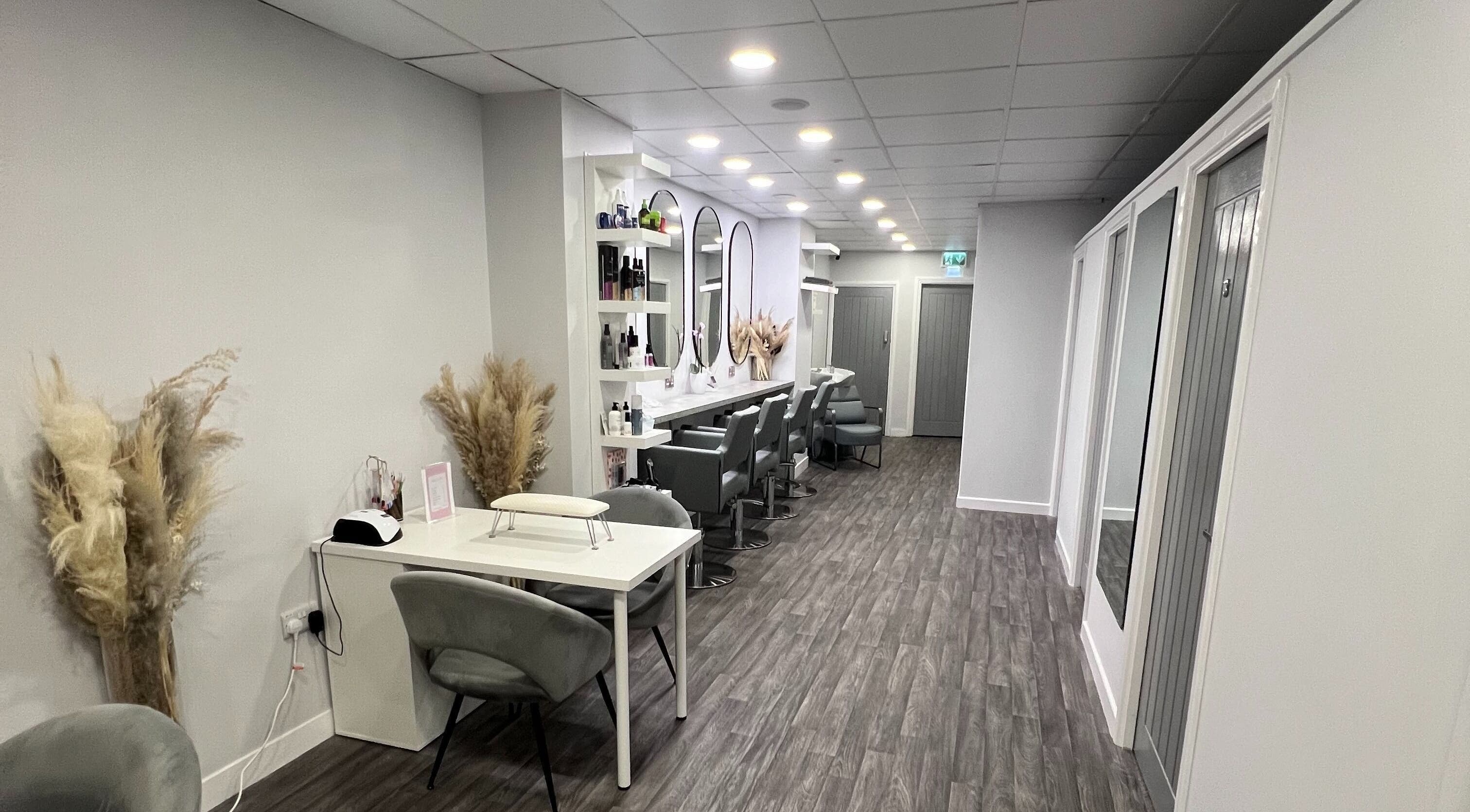 Elegant beauty salon interior at House of Boo, Petersfield, England, GB showcasing modern decor and styling stations.