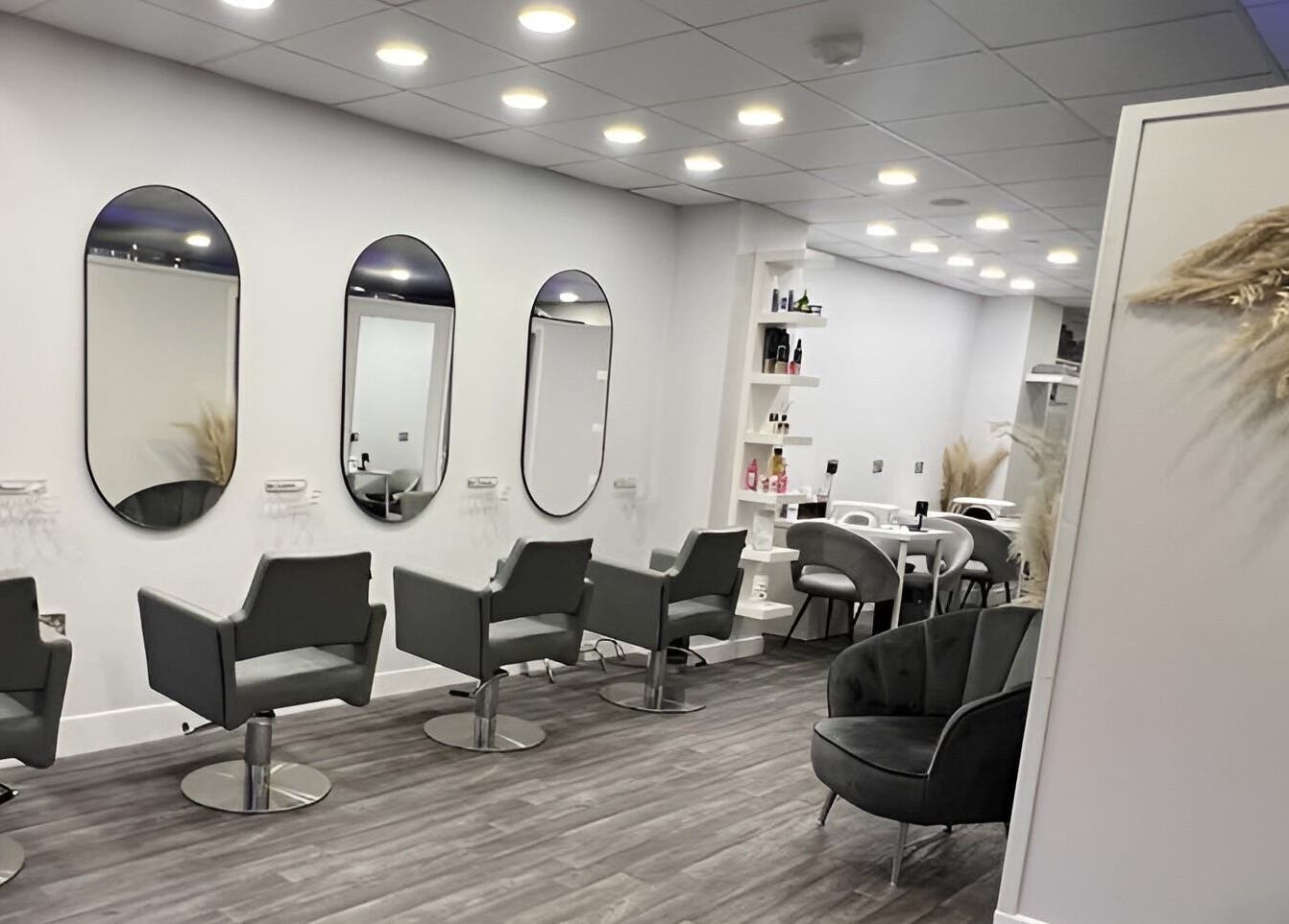 Elegant interior of House of Boo salon in Petersfield, England, GB with sleek chairs and mirrors.