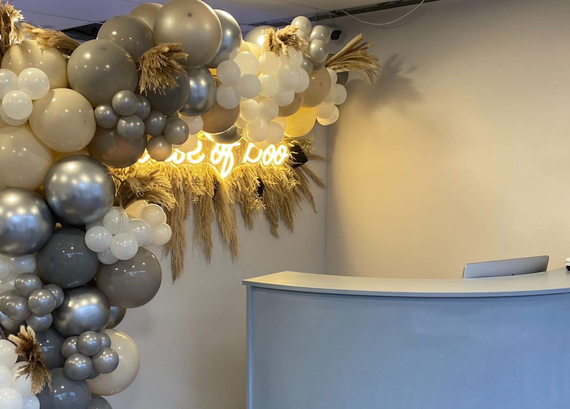 Decorative balloons at House of Boo, Petersfield, England, GB, with a welcoming reception desk.