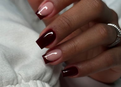 Stylishly manicured nails with burgundy polish at Studio Karla Horrana in Amsterdam, Noord-Holland, NL.