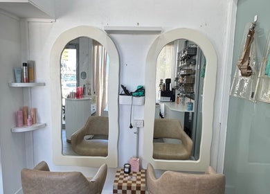 Chic hair styling station at Isla Hair, Maroochydore, Queensland, AU with elegant mirrors and salon chairs.